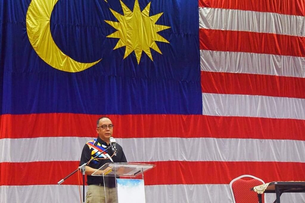 ADUN Hulu Kinta, Datuk Aminuddin Md. Hanafiah berdiri berlatarbelakangkan Bendera Besar Jalur Gemilang yang dibuat oleh Jabatan Farmasi KSKB, dan pernah dibawa ke 'base camp' Gunung Himalaya.