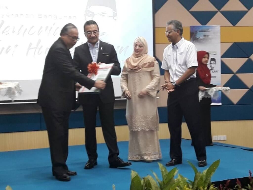Datuk Azmir Merican menyerahkan sijil GBI kepada Datuk Azemi Abd Aziz, disaksikan Datuk Seri Hishammudin Tun Hussien