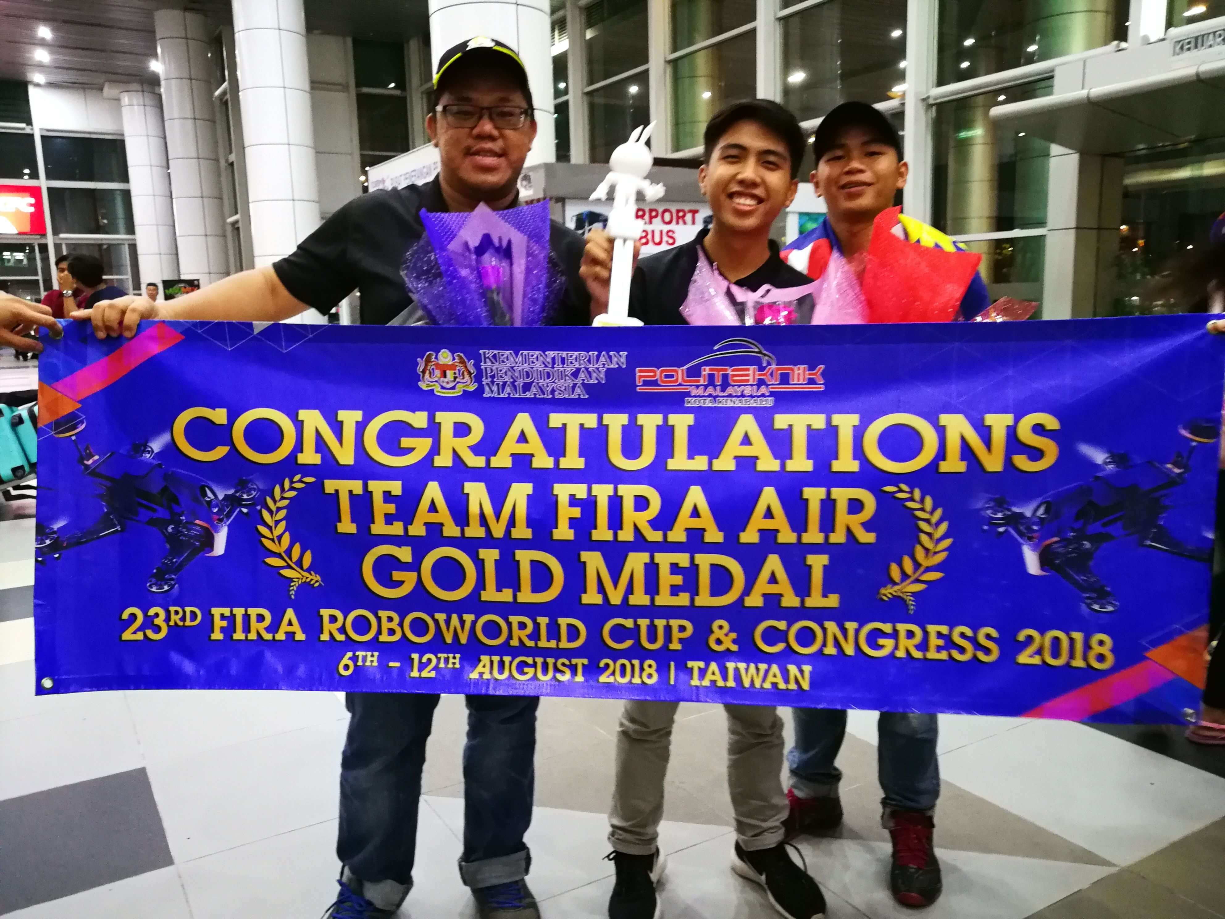 GOLD FOR MALAYSIA ! Team FIRA Air comprising of Wong Wei Ming (left), Mohd. Hariz (centre) and Rekimi pose for a picture upon their arrival at the KKIA Airport.
