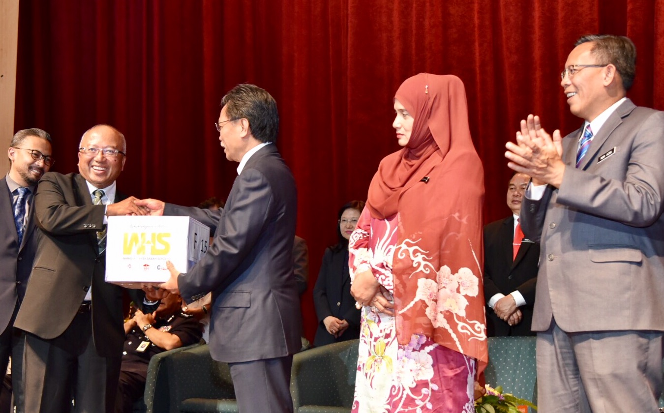 Setiausaha Kerajaan Negeri, Datuk Seri Panglima Hashim Paijan (dua dari kiri) menyampaikan sumbangan kuih raya bagi pihak Warisan Harta Sabah (WHS) kepada Shafie (tengah).