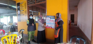 Penolong Pegawai Jabatan Sukarelawan Malaysia (RELA) Daerah Dungun, Noraliza Mat bersama mengedarkan risalah Kempen Pembudayaan Norma Baharu di sekitar Dungun.