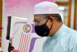 Mohd Nor memeriksa suhu badan sebelum majlis pelancaran Pembudayaan Norma Baharu : Putuskan Rantaian COVID-19 peringkat Negeri Terengganu di Wisma Darul Iman, Kuala Terengganu.