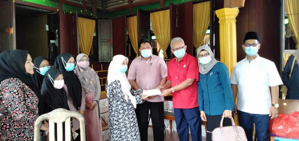 Nur Diana Kamaruzain (kiri) menerima sumbangan dari Exco Pendidikan, Penerangan, Warisan dan Budaya Negeri Johor.