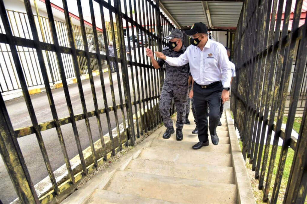 TINJAU...Takiyuddin (kanan) meninjau keadaan dan keperluan di Depot Imigresen KK, diiringi Sade (kiri).