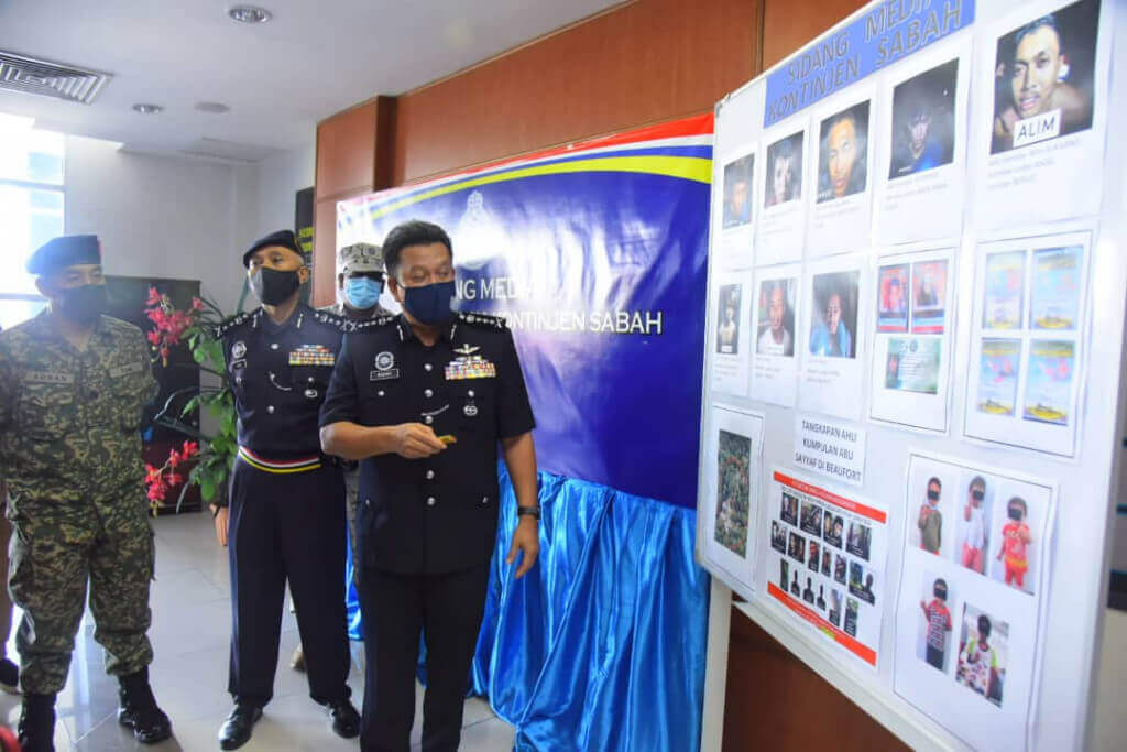 Hazani (kanan) menunjukkan foto 37 individu yang ditangkap di Beaufort.
