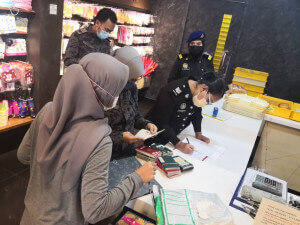 Pegawai dari Pejabat Imigresen Teluk Intan memeriksa dokumen pengenalan diri pekerja-pekerja warga asing di sebuah premis menjual makanan.